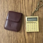 Ambassador Mini Calculator Keychain Keyring, Gold/black Plastic Electronics. Fixed Price $10.00.