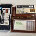 Vtg Canon Checkbook Money Calculator Check Holder Brown Nos. Fixed Price $35.77.