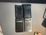 Lot Of 2 Hewlett Packard 10b Business & Texas Instrument Ti-40-w/cases Batt-. Fixed Price $19.95.