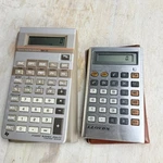 Vintage Texas Inst. Ba-35 & Lloyds Model E615-2 Calculators Lot Of 2 With Sleeve. Fixed Price $12.41.
