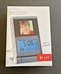 Brookstone Digital Photo Clock 1.4 Inch Lcd. Fixed Price $16.95.